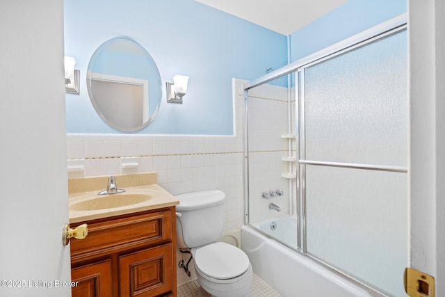 4011 White Plains Ct, Louisville, KY 40218 - bathroom featuring vanity, bath / shower combo with glass door, tile patterned floors, tile walls, and wainscoting