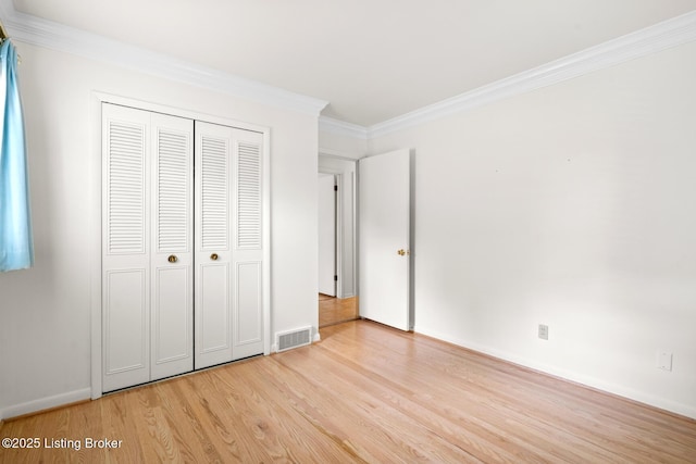 4011 White Plains Ct, Louisville, KY 40218 - unfurnished bedroom featuring light wood-style floors, ornamental molding, and a closet