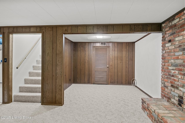 4011 White Plains Ct, Louisville, KY 40218 - finished below grade area featuring carpet flooring, wooden walls, stairs, and brick wall