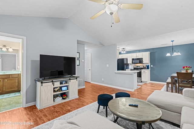 10200 Deer Vista Dr Unit 201, Louisville, KY 40291 - living room with vaulted ceiling, a ceiling fan, light wood finished floors, a chandelier, and baseboards