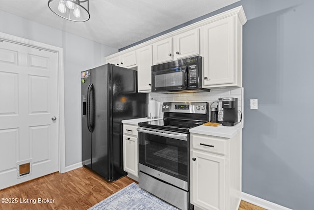 10200 Deer Vista Dr Unit 201, Louisville, KY 40291 - kitchen with black appliances, white cabinetry, light wood-style flooring, and baseboards