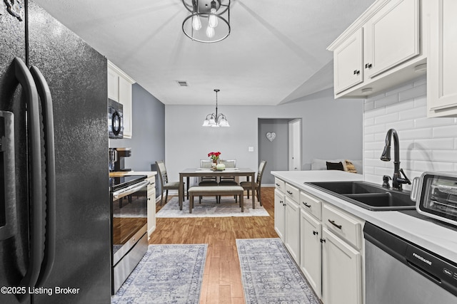 10200 Deer Vista Dr Unit 201, Louisville, KY 40291 - kitchen with black appliances, a sink, light wood-style flooring, tasteful backsplash, and white cabinetry