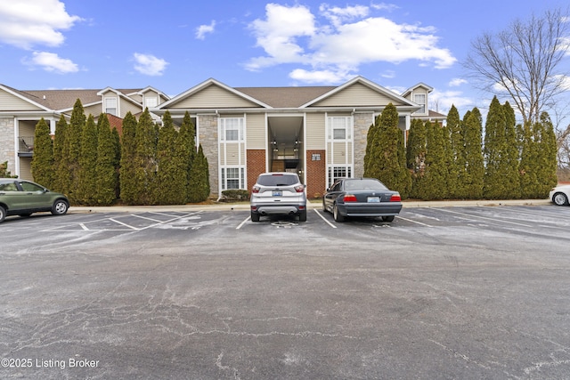 10200 Deer Vista Dr Unit 201, Louisville, KY 40291 - view of front of home featuring stone siding and uncovered parking