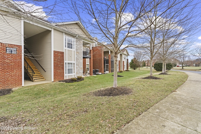 10200 Deer Vista Dr Unit 201, Louisville, KY 40291 - view of side of property with a lawn, brick siding, and stairs