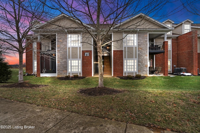10200 Deer Vista Dr Unit 201, Louisville, KY 40291 - view of front facade with stone siding, a lawn, brick siding, and a balcony