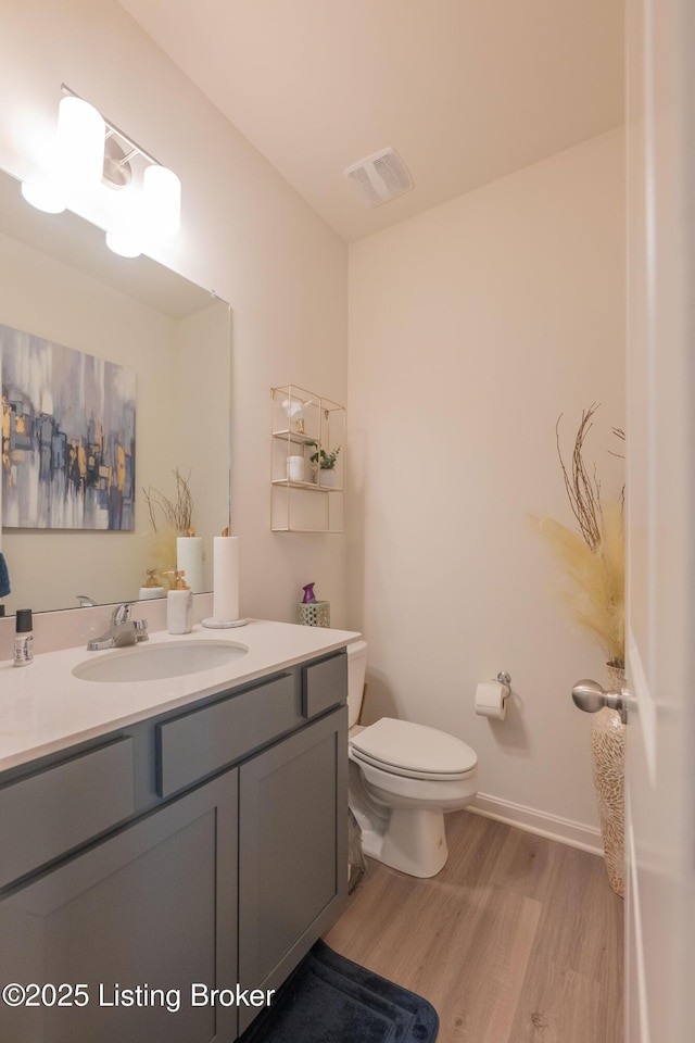 11905 Cascade Falls Trl, Louisville, KY 40229 - half bath featuring wood finished floors, toilet, vanity, and baseboards