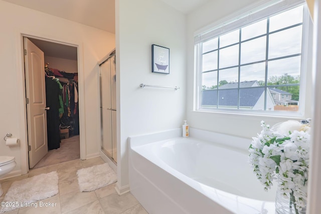 11905 Cascade Falls Trl, Louisville, KY 40229 - bathroom with a garden tub, a stall shower, toilet, a spacious closet, and tile patterned flooring