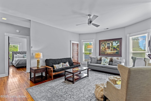 living area featuring hardwood / wood-style flooring and a ceiling fan