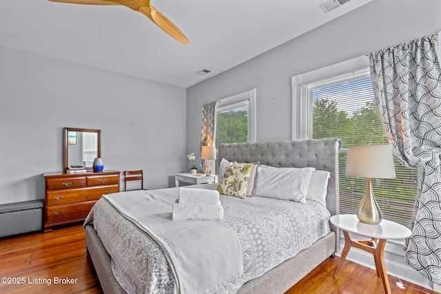 bedroom with wood-type flooring and a ceiling fan