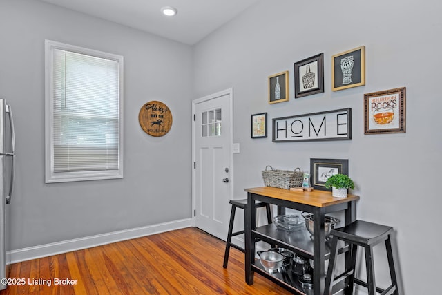 entryway featuring baseboards, wood finished floors, and recessed lighting