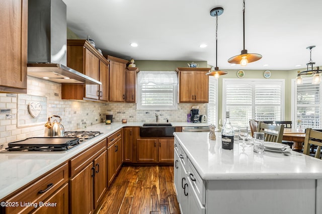 17900 Meremont Heights Way, Louisville, KY 40245 - kitchen featuring wall chimney range hood, stainless steel gas cooktop, brown cabinetry, plenty of natural light, and recessed lighting