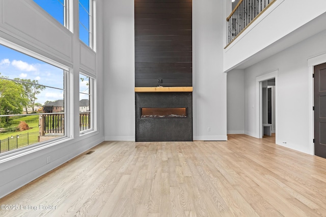 118 Stable Way, Jeffersonville, IN 47130 - unfurnished living room featuring a high ceiling, wood finished floors, baseboards, and a fireplace