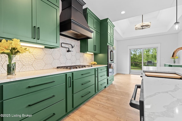 118 Stable Way, Jeffersonville, IN 47130 - kitchen with custom range hood, stainless steel appliances, light wood-style floors, a tray ceiling, and decorative backsplash