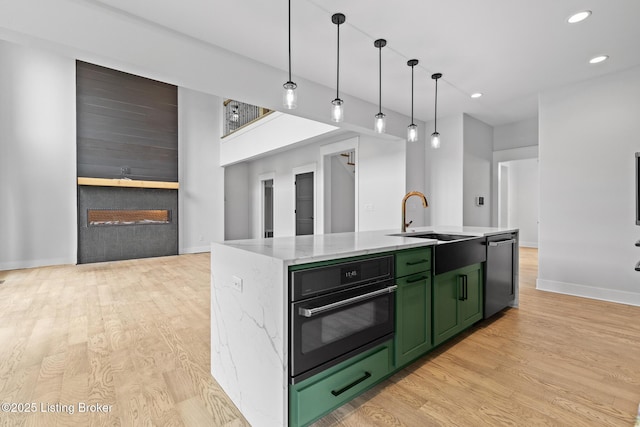 118 Stable Way, Jeffersonville, IN 47130 - kitchen featuring green cabinetry, dishwasher, black oven, light wood-style floors, and a sink
