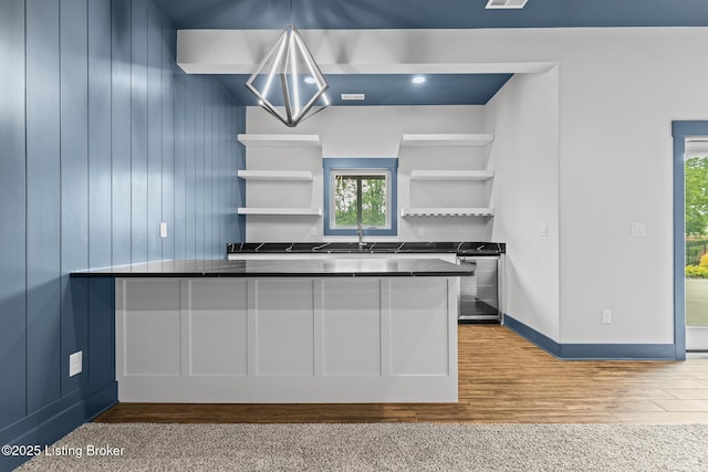 118 Stable Way, Jeffersonville, IN 47130 - kitchen with dark countertops, open shelves, wood finished floors, baseboards, and a sink
