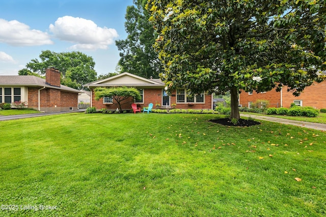 7314 Maria Ave, Louisville, KY 40222 - view of front of house featuring brick siding, a front lawn, and a chimney