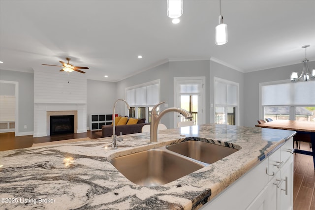 13005 Vista Dr, Prospect, KY 40059 - kitchen with a sink, wood finished floors, light stone counters, a ceiling fan, and decorative light fixtures