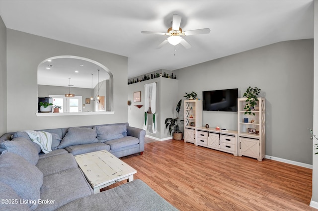 11601 Top Walnut Loop, Louisville, KY 40229 - living room featuring a ceiling fan, light wood finished floors, baseboards, and arched walkways