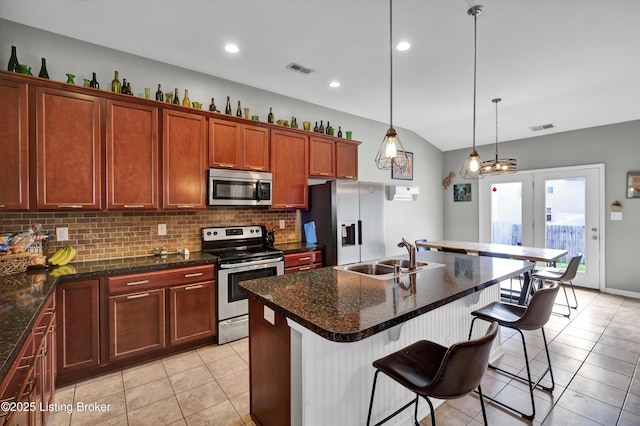 11601 Top Walnut Loop, Louisville, KY 40229 - kitchen featuring appliances with stainless steel finishes, a sink, light tile patterned floors, backsplash, and a breakfast bar