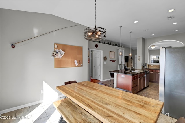 11601 Top Walnut Loop, Louisville, KY 40229 - dining space with light tile patterned flooring, lofted ceiling, arched walkways, recessed lighting, and baseboards