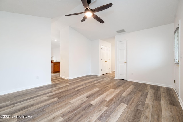 4225 Treesdale Dr, Sellersburg, IN 47172 - unfurnished bedroom with wood finished floors, lofted ceiling, baseboards, ensuite bathroom, and a ceiling fan