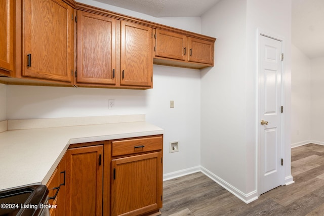 4225 Treesdale Dr, Sellersburg, IN 47172 - kitchen with dark wood finished floors, brown cabinetry, light countertops, and baseboards