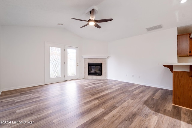 4225 Treesdale Dr, Sellersburg, IN 47172 - unfurnished living room featuring ceiling fan, lofted ceiling, wood finished floors, a tiled fireplace, and baseboards
