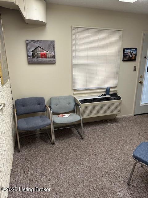 4012 Dupont Cir Unit 214, Louisville, KY 40207 - sitting room featuring carpet flooring and a wall mounted AC
