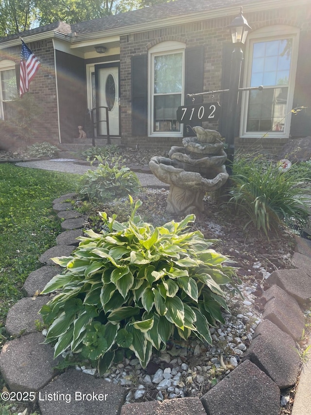 7102 Gorham Way, Louisville, KY 40291 - doorway to property with brick siding and a shingled roof