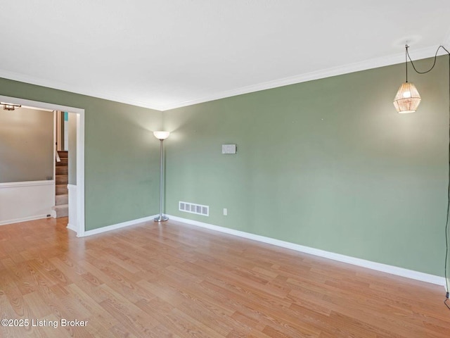 8703 Bards Ct, Louisville, KY 40299 - spare room featuring light wood-type flooring, ornamental molding, stairway, and baseboards