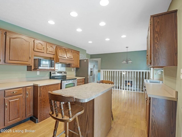 8703 Bards Ct, Louisville, KY 40299 - kitchen with stainless steel appliances, a sink, light wood-type flooring, recessed lighting, and a kitchen island