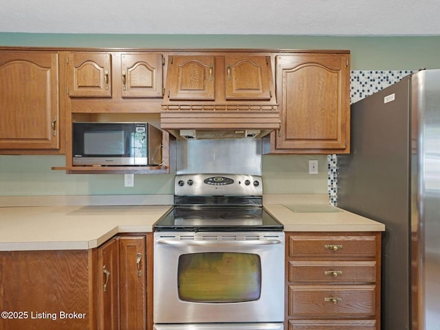 8703 Bards Ct, Louisville, KY 40299 - kitchen with stainless steel appliances, light countertops, brown cabinetry, and range hood