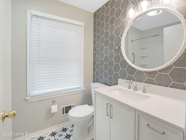 8703 Bards Ct, Louisville, KY 40299 - full bathroom featuring toilet, vanity, baseboards, tile walls, and a shower