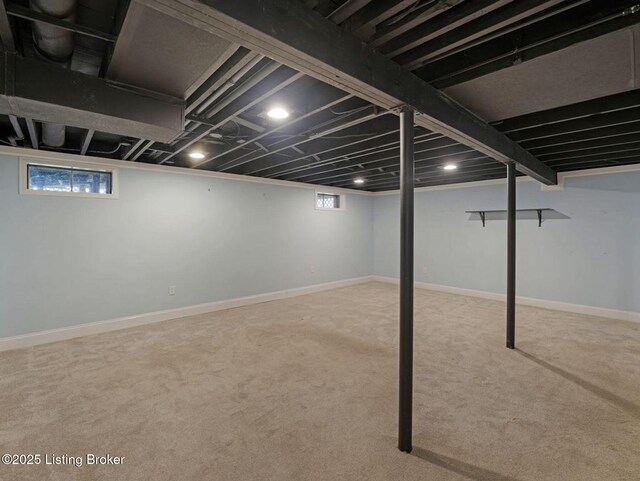 8703 Bards Ct, Louisville, KY 40299 - below grade area featuring carpet flooring, healthy amount of natural light, and baseboards