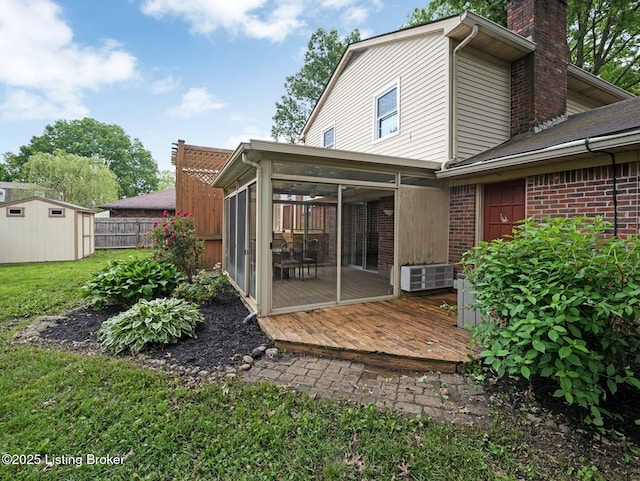 8703 Bards Ct, Louisville, KY 40299 - back of house featuring a sunroom, a chimney, a deck, and brick siding