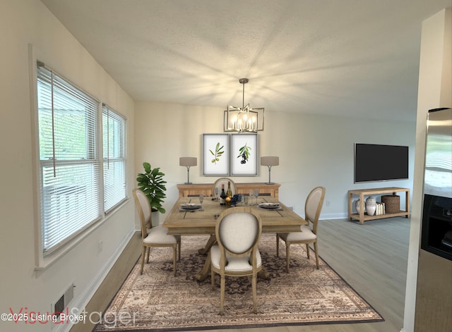 11302 Deering Rd, Louisville, KY 40272 - dining space featuring a chandelier, wood finished floors, and a textured ceiling