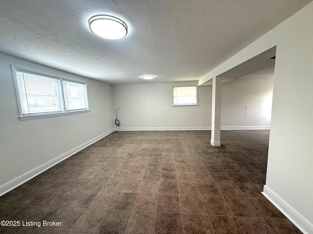 11302 Deering Rd, Louisville, KY 40272 - below grade area with a textured ceiling and dark tile patterned flooring