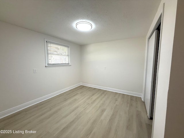 11302 Deering Rd, Louisville, KY 40272 - unfurnished bedroom with a textured ceiling, light wood-style floors, and a closet