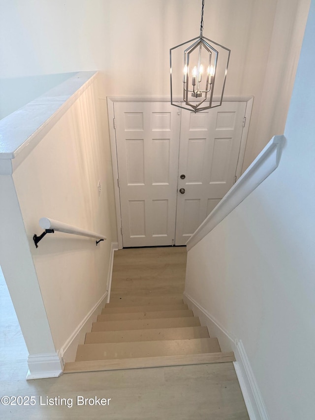 11302 Deering Rd, Louisville, KY 40272 - staircase featuring a chandelier and wood finished floors