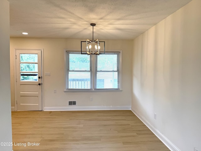 11302 Deering Rd, Louisville, KY 40272 - unfurnished dining area featuring light wood-type flooring, a chandelier, a textured ceiling, and recessed lighting
