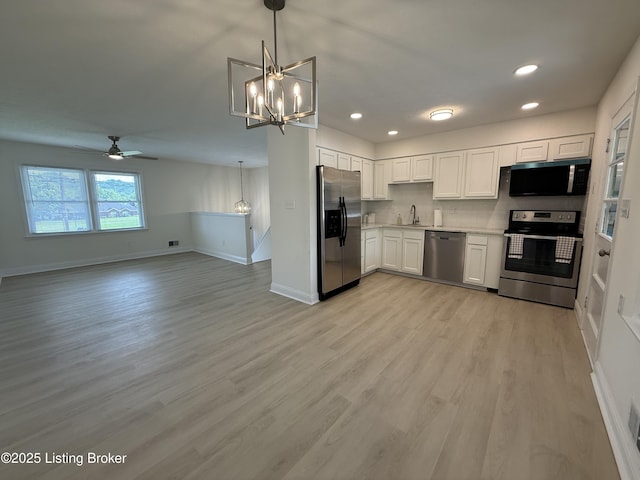 11302 Deering Rd, Louisville, KY 40272 - kitchen with stainless steel appliances, a ceiling fan, a chandelier, light countertops, and light wood-type flooring