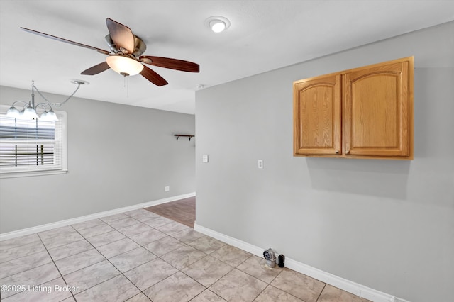 6106 Dobson Ct, Louisville, KY 40229 - spare room featuring a ceiling fan, baseboards, a chandelier, and light tile patterned floors
