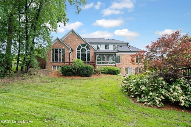 527 Woodlake Dr, Louisville, KY 40245 - rear view of house featuring brick siding, a lawn, and a sunroom