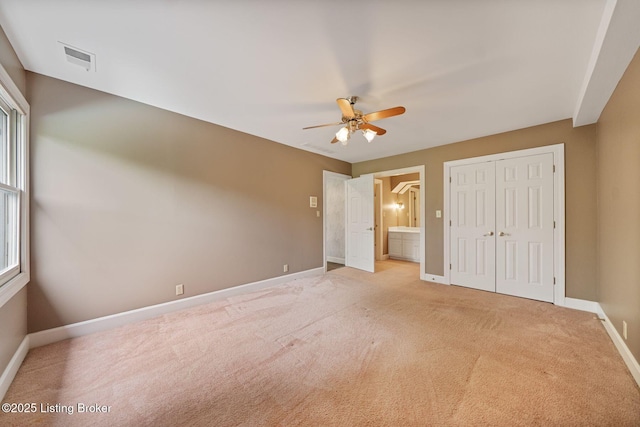 527 Woodlake Dr, Louisville, KY 40245 - unfurnished bedroom featuring light colored carpet, a closet, ensuite bath, and a ceiling fan