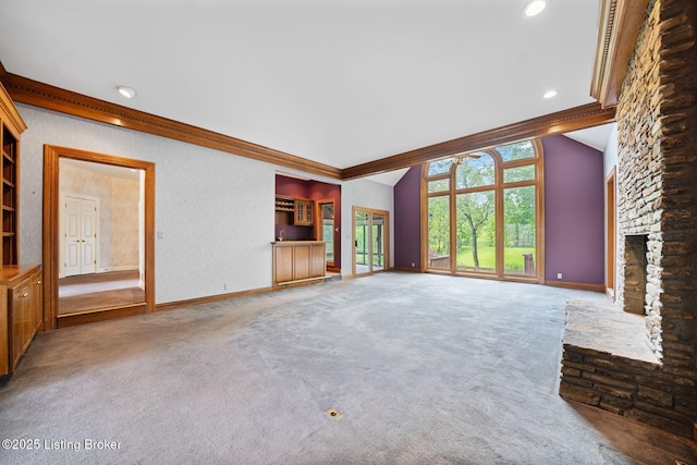 527 Woodlake Dr, Louisville, KY 40245 - unfurnished living room with carpet flooring, a stone fireplace, vaulted ceiling, ornamental molding, and recessed lighting