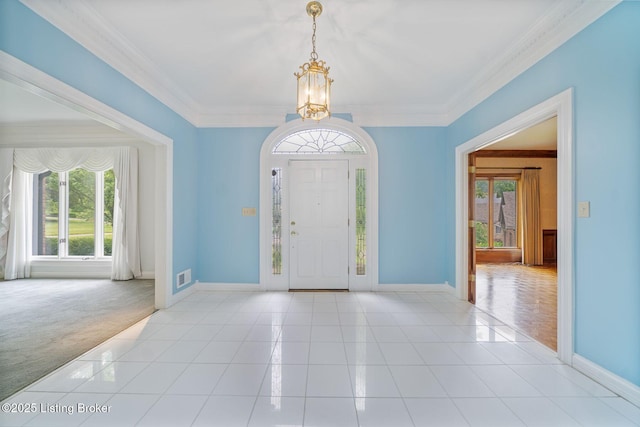 527 Woodlake Dr, Louisville, KY 40245 - foyer with a chandelier, light tile patterned floors, ornamental molding, and light carpet