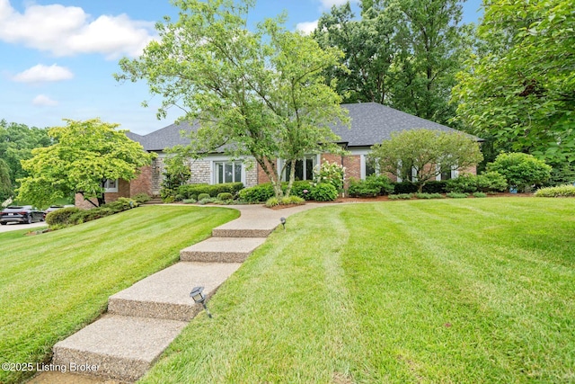 527 Woodlake Dr, Louisville, KY 40245 - view of front of house featuring brick siding, a front yard, and a shingled roof