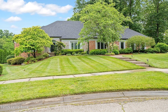 527 Woodlake Dr, Louisville, KY 40245 - view of front of property featuring a front lawn, a shingled roof, and brick siding