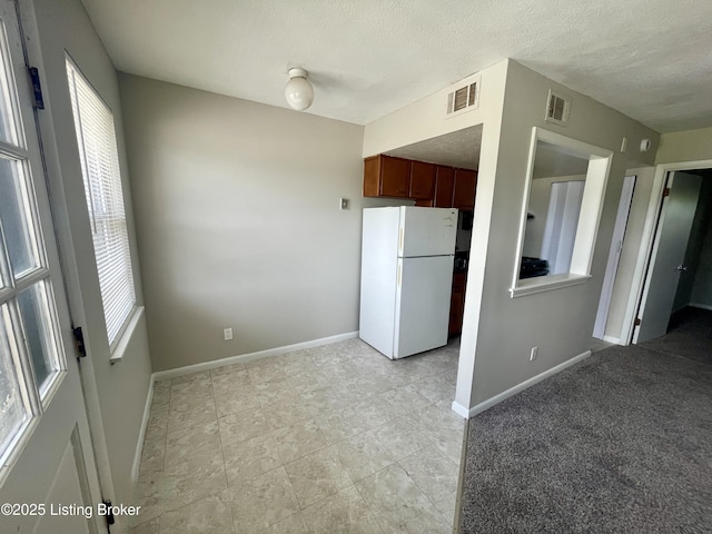 4143 Hillview Ave, Louisville, KY 40216 - kitchen featuring freestanding refrigerator, baseboards, a textured ceiling, and light tile patterned floors