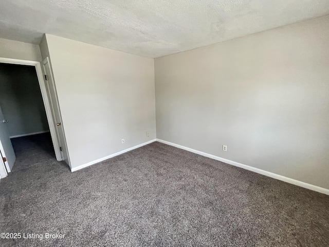 4143 Hillview Ave, Louisville, KY 40216 - spare room featuring dark colored carpet, baseboards, and a textured ceiling